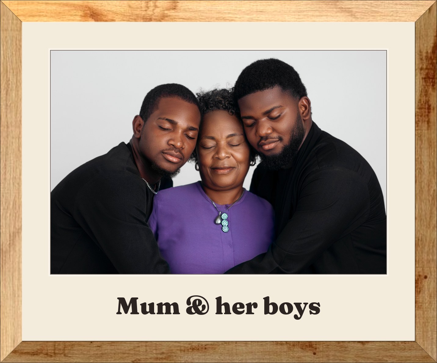 A mother with her two grown sons, framed in oak